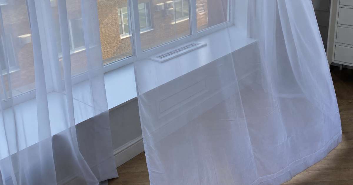Draughty windows letting cold air into a living room in winter